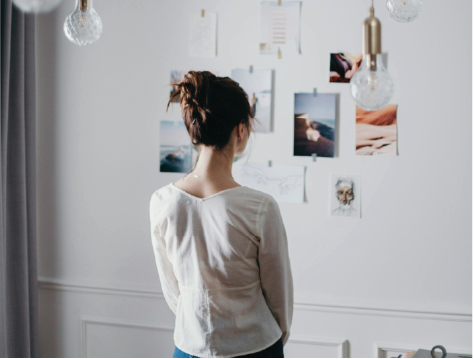 Woman looking at vision board on wall